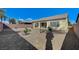 Expansive desert landscaped backyard with a covered patio, offering privacy and minimal upkeep for a serene outdoor space at 3335 American Mustang Ct, Las Vegas, NV 89122