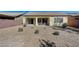 Spacious backyard featuring low-maintenance desert landscaping, a covered patio, and privacy fencing, perfect for outdoor living at 3335 American Mustang Ct, Las Vegas, NV 89122