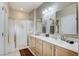 Bathroom featuring a dual sink vanity, mirrors, and glass shower at 3335 American Mustang Ct, Las Vegas, NV 89122