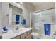 Bathroom with glass enclosed shower, vanity with mirror and blue towels at 3335 American Mustang Ct, Las Vegas, NV 89122
