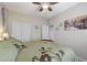 Bedroom with neutral walls, a ceiling fan, green bedding and closet at 3335 American Mustang Ct, Las Vegas, NV 89122