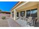 Covered patio featuring a comfortable seating area and a decorative rug, extending the living space outdoors for relaxation and entertainment at 3335 American Mustang Ct, Las Vegas, NV 89122
