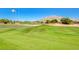 Well-manicured golf course featuring lush green grass, distant mountains, and clear blue skies at 3335 American Mustang Ct, Las Vegas, NV 89122