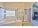 Bathroom featuring a bathtub, shower, and a grey wood-look flooring at 3525 Dover Bay St, Las Vegas, NV 89129
