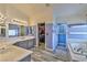 Spacious bathroom featuring a double vanity, walk-in closet, soaking tub and grey wood-look flooring at 3525 Dover Bay St, Las Vegas, NV 89129
