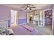 Bedroom with soft carpet, stylish built-in shelving and desk, plus walk-in closet access for ample storage at 3525 Dover Bay St, Las Vegas, NV 89129