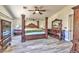 Large bedroom featuring a bed set, ceiling fan, and a grey laminate floor at 3525 Dover Bay St, Las Vegas, NV 89129