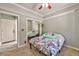 Bedroom featuring a ceiling fan and a double door closet that has mirrors at 3525 Dover Bay St, Las Vegas, NV 89129