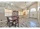 Open dining area with vaulted ceiling, wood floors, chandelier, and natural light at 3525 Dover Bay St, Las Vegas, NV 89129