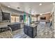 An open concept living room and kitchen, featuring a fireplace and laminate flooring at 3525 Dover Bay St, Las Vegas, NV 89129