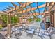 Inviting covered patio with comfortable seating, offering a relaxing outdoor space with views of the backyard at 3525 Dover Bay St, Las Vegas, NV 89129
