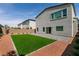 A home's exterior featuring a small grassy backyard, surrounded by pavers and low-maintenance desert landscaping at 363 Terrill Ave, Las Vegas, NV 89183