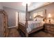 Bedroom featuring a four-poster bed, matching nightstands, and ample closet space at 363 Terrill Ave, Las Vegas, NV 89183