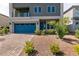 Contemporary two-story home with blue garage door, minimal landscaping, and a brick driveway at 363 Terrill Ave, Las Vegas, NV 89183