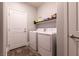 Bright laundry room with modern washer and dryer units, and ample shelving at 363 Terrill Ave, Las Vegas, NV 89183