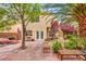 Backyard with paved patio and a shady spot to relax under mature trees and a lawn at 3735 Morning Canyon St, Las Vegas, NV 89147