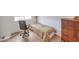 This bedroom shows a single bed, desk chair, and a wood dresser against a white wall at 3735 Morning Canyon St, Las Vegas, NV 89147