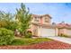 Inviting two-story home with a two-car garage and well-manicured lawn at 3735 Morning Canyon St, Las Vegas, NV 89147