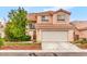 Charming two-story home featuring a terracotta roof, a well-manicured lawn, and a spacious two-car garage at 3735 Morning Canyon St, Las Vegas, NV 89147