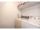 A compact laundry room is equipped with a washer, dryer, and overhead storage shelf at 3735 Morning Canyon St, Las Vegas, NV 89147