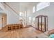 Open-concept living room featuring high ceilings, a wooden staircase, and plenty of natural light at 3735 Morning Canyon St, Las Vegas, NV 89147