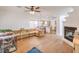 Spacious living room showcases wood floors, a fireplace, ceiling fan, and flows into an open-concept kitchen area at 3735 Morning Canyon St, Las Vegas, NV 89147