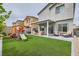Expansive backyard featuring artificial turf, play structure, and a covered patio area at 3903 Ramura Ave, North Las Vegas, NV 89084