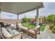 Inviting backyard featuring a covered patio, artificial turf, and a fun play structure at 3903 Ramura Ave, North Las Vegas, NV 89084