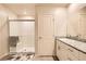 Clean and functional bathroom with double sinks, white cabinetry, and a walk-in shower at 3903 Ramura Ave, North Las Vegas, NV 89084