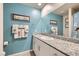 Bathroom with a granite countertop, a modern mirror, and cute character-themed towels at 3903 Ramura Ave, North Las Vegas, NV 89084