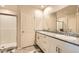 Modern bathroom featuring double sinks, granite countertops, and a glass-enclosed shower at 3903 Ramura Ave, North Las Vegas, NV 89084