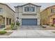 Two-story home showcasing a symmetrical facade, a two-car garage, and manicured landscaping at 3903 Ramura Ave, North Las Vegas, NV 89084
