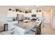 Well-lit kitchen featuring white cabinets, stainless steel appliances, and a granite-topped island with barstool seating at 3903 Ramura Ave, North Las Vegas, NV 89084