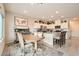 Eat-in kitchen and dining area featuring white cabinets and granite countertops at 3903 Ramura Ave, North Las Vegas, NV 89084