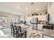 Open kitchen with stainless steel appliances, granite countertops, and a large island with seating at 3903 Ramura Ave, North Las Vegas, NV 89084