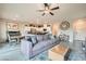 Open-concept living area with modern furnishings, tile flooring, and a view into the kitchen at 3903 Ramura Ave, North Las Vegas, NV 89084
