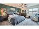 Comfortable main bedroom with a plush upholstered bed, decorative wall art, and a view-enhancing window at 3903 Ramura Ave, North Las Vegas, NV 89084