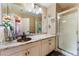 Bathroom featuring dual sinks with stylish fixtures, granite countertop, and a glass-enclosed shower at 3921 White Castle St, Las Vegas, NV 89129