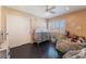 Cozy bedroom with wood floors, white shutters, and a ceiling fan at 3921 White Castle St, Las Vegas, NV 89129
