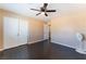 Bright bedroom features dark wood-look floors and a ceiling fan at 3921 White Castle St, Las Vegas, NV 89129
