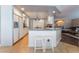 Bright white kitchen with granite countertops, stainless steel appliances, and a breakfast bar with seating at 3921 White Castle St, Las Vegas, NV 89129