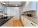 Modern kitchen features white cabinets, granite countertops, mosaic backsplash and center island at 3921 White Castle St, Las Vegas, NV 89129