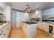 Bright kitchen featuring an island, white cabinetry, granite counters, and modern appliances at 3921 White Castle St, Las Vegas, NV 89129
