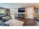 Open-concept living room with tile flooring, fireplace, and staircase leading to upper level at 3921 White Castle St, Las Vegas, NV 89129