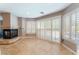 Bright living room with a cozy fireplace, shuttered windows, and tile flooring at 3921 White Castle St, Las Vegas, NV 89129