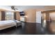 Spacious main bedroom with dark wood floors, ceiling fan, dresser, and natural light from a window at 3921 White Castle St, Las Vegas, NV 89129