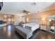 Spacious main bedroom with dark wood floors, a seating area, and abundant natural light at 3921 White Castle St, Las Vegas, NV 89129
