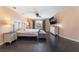 Spacious main bedroom with dark wood floors, ceiling fan, dresser, and natural light from a window at 3921 White Castle St, Las Vegas, NV 89129