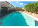 Backyard pool reflecting blue sky and desert landscaping at 3921 White Castle St, Las Vegas, NV 89129