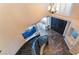 Grand staircase view from above with dark wood steps and tile flooring with an elegant chandelier at 3921 White Castle St, Las Vegas, NV 89129